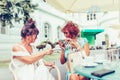 Happy female friends talking and drinking coffee  in a outdoor cafe Royalty Free Stock Photo