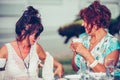 Two happy senior women talking and enjoying coffee together in a in cafe Royalty Free Stock Photo