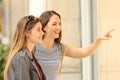 Two happy shoppers watching a storefront