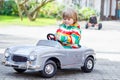 Two happy sibling boys playing with big old toy car Royalty Free Stock Photo