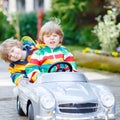 Two happy sibling boys playing with big old toy Royalty Free Stock Photo