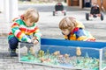 Two happy sibling boys playing with sodier toys Royalty Free Stock Photo