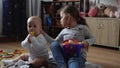 Two Happy Siblings Children Boy Girl In Playing Room. Kids Infand and Preschool Play With Wooden Toy At Home Build