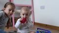 Two Happy Siblings Children Boy Girl In Playing Room. Kids Infand and Preschool Play With Wooden Toy At Home Build