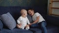 Two Happy Siblings Children Boys Brothers In Playing Room. Kids Infand and Preschool Play On Comfortable Sofa Watching