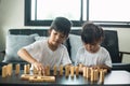 Two happy siblings playing a game with wooden blocks at home joyfully Royalty Free Stock Photo
