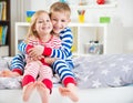 Two happy siblings in sleepwears in bed