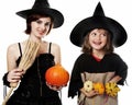 Two happy sisters with hallowen witch masks