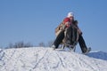 Two happy sisters sledding Royalty Free Stock Photo