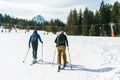 Two happy skiers go to the ski lift on a winter day.