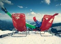 Two happy skiers on the top of mountain