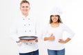 Two happy smile chefs holding an empty tray and show like sign isolated on white. White and afro american cookers in uniform Royalty Free Stock Photo