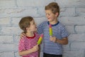 Happy smiling boys are eating ice cream. Children hugging eat fruit frozen ice Royalty Free Stock Photo