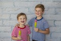 Happy smiling boys are eating ice cream. Children hugging eat fruit frozen ice Royalty Free Stock Photo