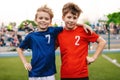 Two Happy Smiling Boys in Sports Team Standing on Grass Pitch Royalty Free Stock Photo