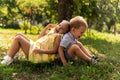 Two happy smiling cheerful toddler preschool twins siblings children brother sister boy girl sitting together on grass Royalty Free Stock Photo