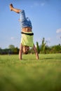 two happy smiling children tumbling on green grass. Cheerful brother and sister laugh together. Happy kids have fun on