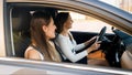 Two happy smiling girls driving a car on city street Royalty Free Stock Photo