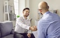 Two business people in office making deal. Two men shaking hands celebrating business achievement. Royalty Free Stock Photo