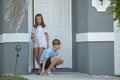 Two happy smiling teenage children, boy and girl going outdoors for having fun on summer sunny day Royalty Free Stock Photo