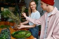 Two happy and smiling young florists working together at creative workshop Royalty Free Stock Photo