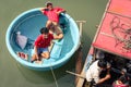 Two happy smiling young men in traditional basket boat on river