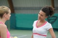 Two happy sporty girls tennis players talking Royalty Free Stock Photo