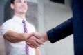 Two happy successful business partner shaking hands in the office. Royalty Free Stock Photo