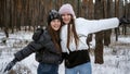 Two happy teenage girls laughing and cheering because of the first snow. People playing outdoors, winter holidays and vacation, Royalty Free Stock Photo