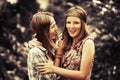 Two happy teen girls walking in summer forest Royalty Free Stock Photo