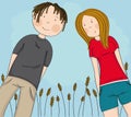 Two happy teenagers, boy and girl looking down at the camera and smiling, blue sky behind them Royalty Free Stock Photo