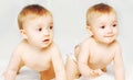 Two happy twins babies crawling on the bed