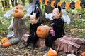 two happy twins boys kids in halloween costumes having fun in halloween decorations outdoor Royalty Free Stock Photo