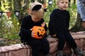 two happy twins boys kids in halloween costumes having fun in halloween decorations outdoor Royalty Free Stock Photo