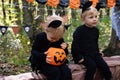 two happy twins boys kids in halloween costumes having fun in halloween decorations outdoor Royalty Free Stock Photo