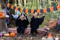 two happy twins boys kids in halloween costumes having fun in halloween decorations outdoor Royalty Free Stock Photo