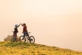 Woman high five over the sunset at mountain biking trip Royalty Free Stock Photo