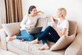 Two happy women gossiping on the sof Royalty Free Stock Photo