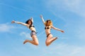 Two happy women jumping high with fun Royalty Free Stock Photo