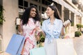 Two Happy Women With Shopping Bags And Takeaway Coffee Walking Outdoors Royalty Free Stock Photo