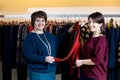 Two happy women shopping in clothes store Royalty Free Stock Photo