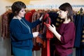 Two happy women shopping in clothes store Royalty Free Stock Photo