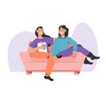 Two happy women sitting on couch and spending time together Royalty Free Stock Photo