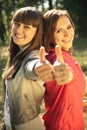 Two happy women with thumbs up Royalty Free Stock Photo