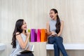 Two happy women using shopping on mobile phone and tablet. Two y Royalty Free Stock Photo