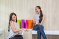 Two happy women using shopping on mobile phone and tablet. Two young women smiling shopping. Female working with tablet using Royalty Free Stock Photo