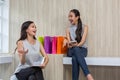 Two happy women using shopping on mobile phone and tablet. Two young women smiling shopping. Female working with tablet using Royalty Free Stock Photo