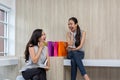 Two happy women using shopping on mobile phone and tablet. Two young women smiling shopping. Female working with tablet using Royalty Free Stock Photo