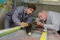 Two happy workmen toiling at locksmiths workshop Royalty Free Stock Photo