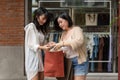 Two happy young Asian female friends are enjoying their shopping spree in the city together Royalty Free Stock Photo